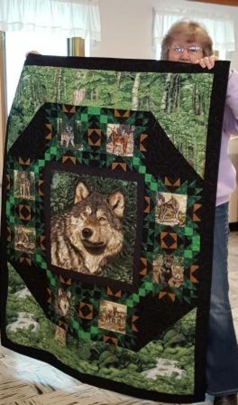 Shirley H shows a lap size Wolf Song quilt